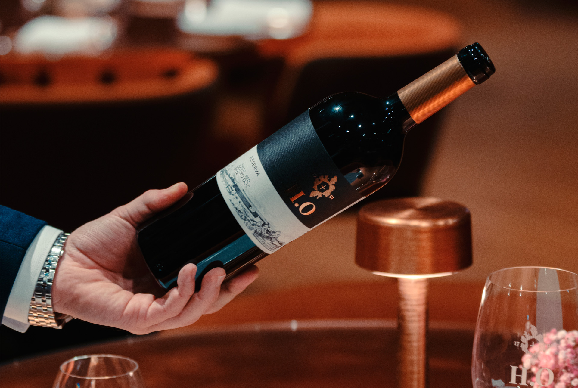 person holding an open bottle of red ho reserve