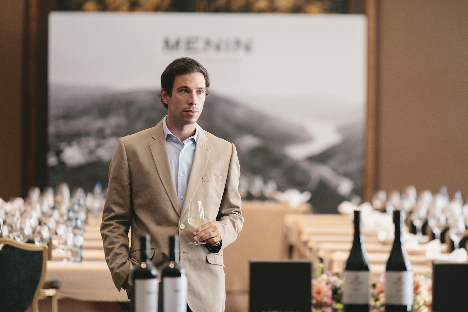 joão rosa alves holding a glass of wine in the middle of a tasting room